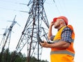 Electrical engineer working. Talking on the phone and working working on a laptop Royalty Free Stock Photo