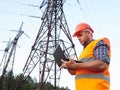 Electrical engineer working. Talking on the phone and working working on a laptop Royalty Free Stock Photo