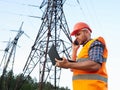 Electrical engineer working. Talking on the phone and working working on a laptop Royalty Free Stock Photo