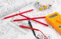 Electrical engineering drawings, circuit breaker, pencils and digital multimeter Royalty Free Stock Photo