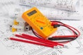 Electrical engineering drawings, circuit breaker, pencils and digital multimeter Royalty Free Stock Photo