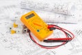 Electrical engineering drawings, circuit breaker, pencils and digital multimeter Royalty Free Stock Photo