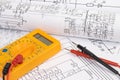 Electrical engineering drawings and digital multimeter Royalty Free Stock Photo