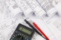 Electrical engineering drawings and digital multimeter Royalty Free Stock Photo