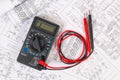 Electrical engineering drawings and digital multimeter. Royalty Free Stock Photo