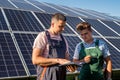 Electrical engineers examining the construction near solar energy batteries Royalty Free Stock Photo