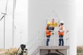 Electrical engineers and technician working in wind turbine