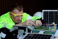 Electrical engineers working with electronic circuit board and solar cells, mechanicals senior men working with electrical