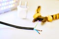 Three-core electric cable, metalwork pliers and LED lamp