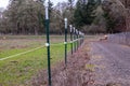 Electrical fence around pasture perimeter at a local farm Royalty Free Stock Photo