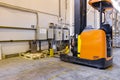 Electrical forklift loader charging in the warehouse. Pallet stacker truck equipment inside of a modern warehouse storage