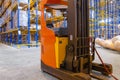 Electrical forklift loader charging in the warehouse. Pallet stacker truck equipment inside of a modern warehouse storage