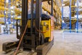 Electrical forklift loader charging in the warehouse. Pallet stacker truck equipment inside of a modern warehouse storage