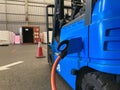 Electrical forklift vehicle park and plug in for charging battery inside of logistic warehouse. Alternative energy source for car Royalty Free Stock Photo