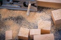 Electrical fretsaw sawdust and wooden bricks on vintage wood background top view image construction concept