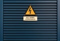 Electrical hazard sign on a triangular yellow sign