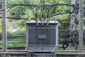 Electrical high voltage transformer on concrete pole.