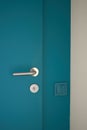 Electrical household navy blue switches in minimalist interior design. Stylish bedroom and livingroom door handle