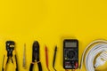 Electrical installation tools on yellow background