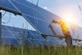 Electrical and instrument technician use battery drill to maintenance electric system at solar panel field Royalty Free Stock Photo