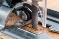 An electrical jigsaw cutting through chip board. Blurred background