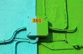 Electrical junction box of a colorful house with written 380 Vol