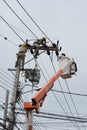 An electrical lineman working on a line