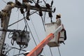 An electrical lineman working on a line