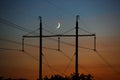 Electrical lines under a night sky with moon Royalty Free Stock Photo