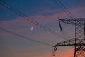 Electrical lines under a night sky with moon Royalty Free Stock Photo