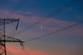 Electrical lines under a night sky with moon Royalty Free Stock Photo