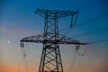 Electrical lines under a night sky with moon Royalty Free Stock Photo