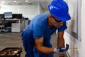 Electrical maintenance inspection.Tehnical maintenance worker checks the electricity in the office premises photo