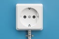 Electrical outlet on the blue wall, 3D Royalty Free Stock Photo