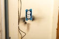 Electrical outlet with burn marks on wall from short circuit