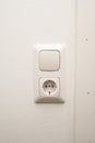 An electrical outlet and light switch on a wall Royalty Free Stock Photo