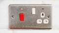 Electrical outlet and switch panel with red button and indicator light Royalty Free Stock Photo