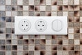 Electrical outlets on the mosaic wall Close-up Royalty Free Stock Photo