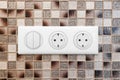 Electrical outlets on the mosaic wall Close-up Royalty Free Stock Photo