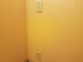 Electrical outlets on orange or yellow painted wall