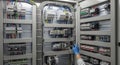 Electrical Panel Interior View Detailed Arrangement of Wires Circuit Breakers and Components with a Hand in Blue Glove for Royalty Free Stock Photo