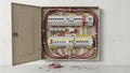 Electrical panel with wires and circuit breakers against white wall background Royalty Free Stock Photo