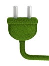 Electrical plug covered by green grass Royalty Free Stock Photo