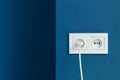 Electrical plug in electric double socket on wall Royalty Free Stock Photo