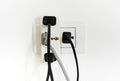 Electrical plug and socket overloaded on white background Royalty Free Stock Photo