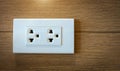 Electrical plug socket on wooden wall Royalty Free Stock Photo