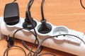 Electrical plugs with cords connected to power strip. Concept of energy saving Royalty Free Stock Photo