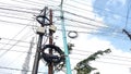 Electrical poles full of tangled cables under the blue sky Royalty Free Stock Photo