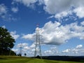 Electrical poles on hill landscape, electric infrastructure.