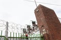 Electrical power facility enclosed with wrought iron fencing, expanded metal, and razor wire